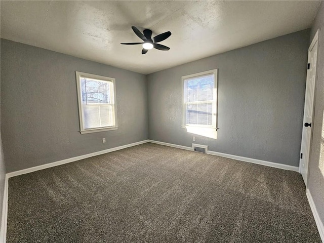 unfurnished room featuring carpet flooring, ceiling fan, and a healthy amount of sunlight