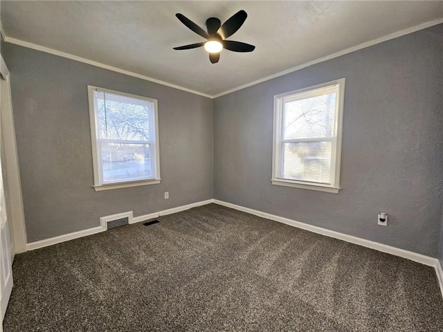 carpeted empty room featuring ceiling fan and crown molding