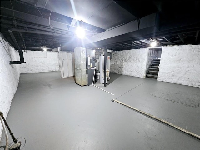 basement featuring gas water heater and heating unit