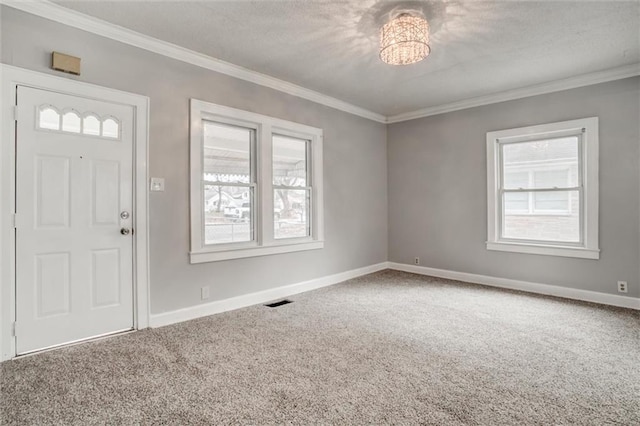 foyer entrance with carpet flooring and ornamental molding