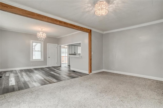 unfurnished living room featuring a chandelier, dark hardwood / wood-style floors, and crown molding