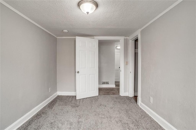 unfurnished bedroom featuring a textured ceiling and light colored carpet