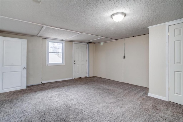 basement featuring a textured ceiling and carpet floors