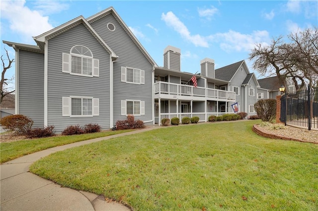 exterior space featuring a yard and a balcony