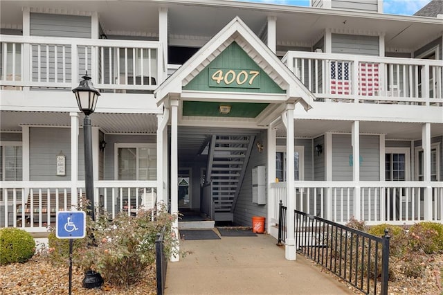 view of exterior entry featuring a balcony