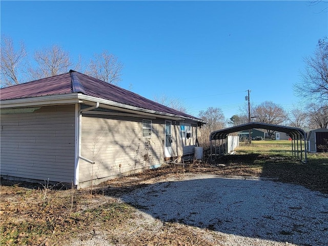 view of side of home with a carport