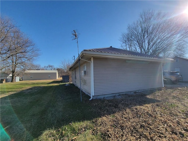 view of home's exterior with a lawn