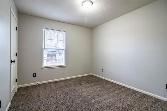 empty room with dark colored carpet