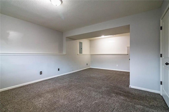 unfurnished room featuring dark colored carpet, a textured ceiling, and electric panel