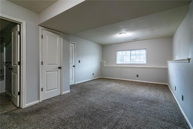 carpeted spare room featuring a textured ceiling