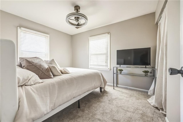 bedroom with multiple windows and light carpet