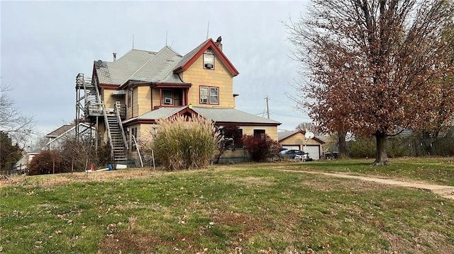 victorian house with a garage and a front yard