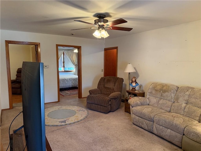 living room featuring light colored carpet and ceiling fan