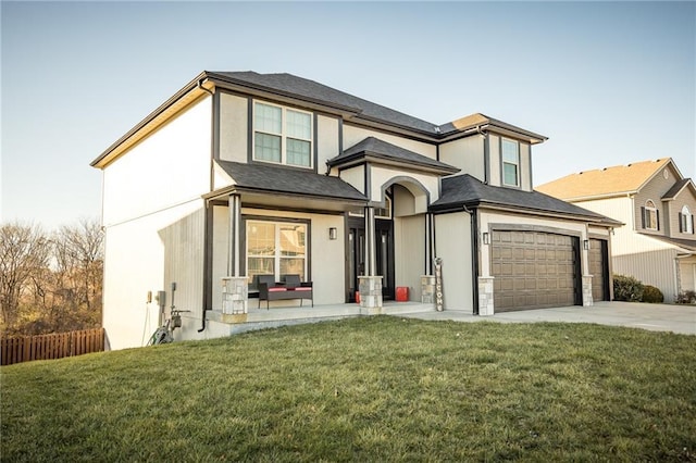 view of front facade with a garage and a front lawn