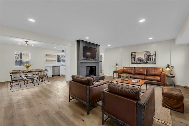 living room featuring a fireplace and light hardwood / wood-style flooring