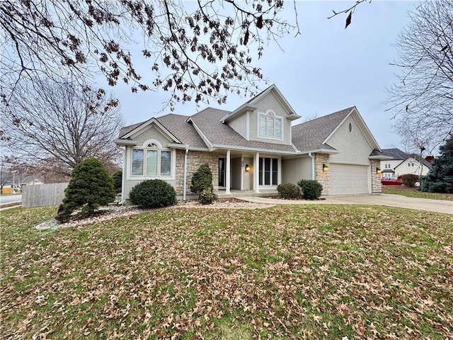 traditional-style home with an attached garage, a front yard, fence, stone siding, and driveway