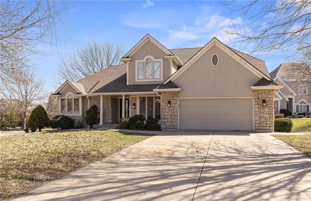 traditional home with stucco siding, stone siding, a garage, and driveway