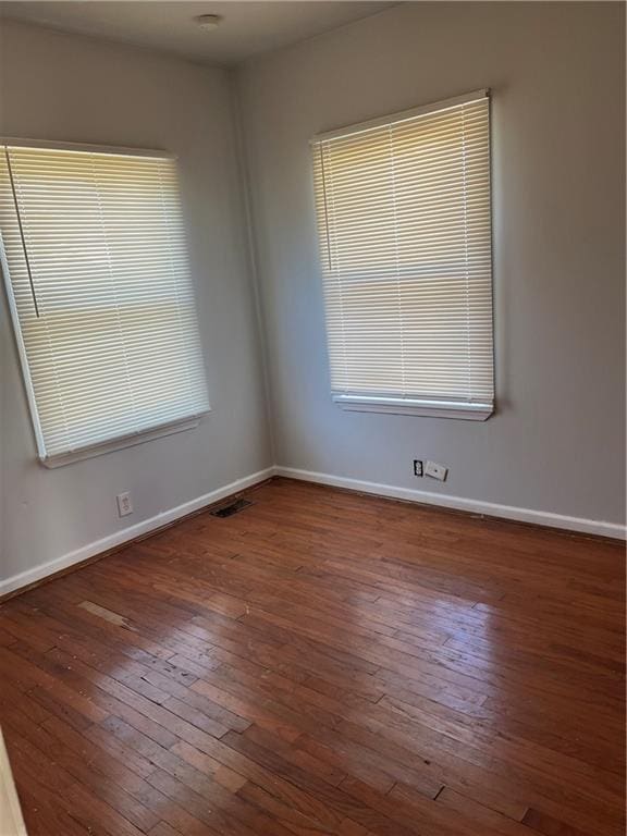 spare room featuring dark hardwood / wood-style flooring