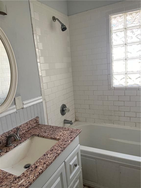 bathroom featuring vanity and tiled shower / bath combo