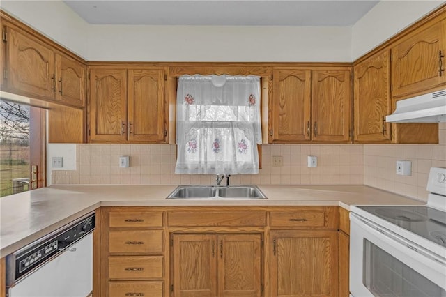 kitchen featuring decorative backsplash, sink, and white appliances