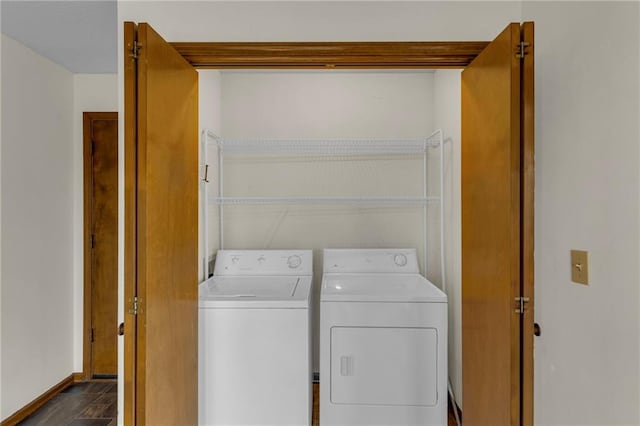 laundry room with independent washer and dryer and dark wood-type flooring