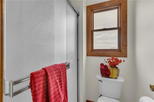 bathroom featuring toilet and walk in shower