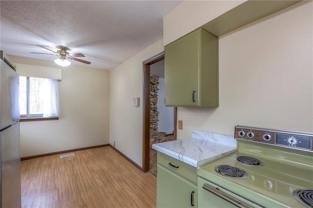 kitchen with ceiling fan, white range with electric stovetop, refrigerator, light hardwood / wood-style floors, and green cabinetry