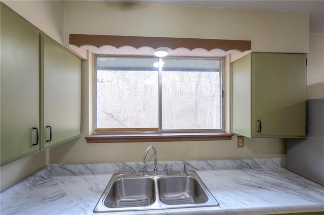 kitchen with green cabinets and sink