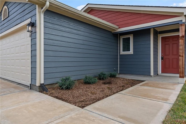 doorway to property with a garage