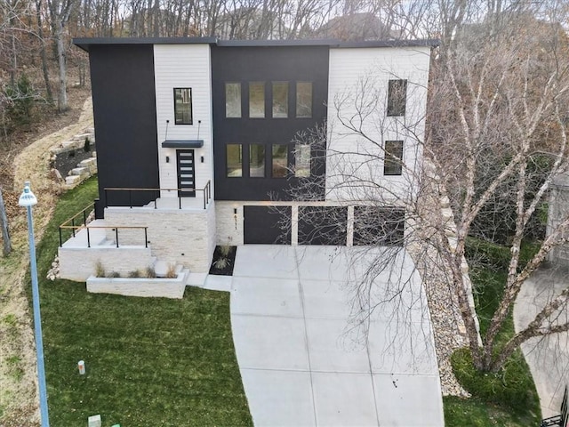 view of front of home featuring stone siding, stucco siding, an attached garage, and concrete driveway