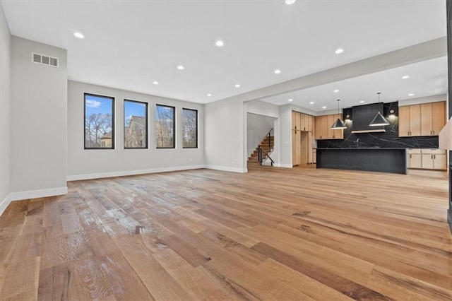 unfurnished living room featuring light hardwood / wood-style flooring