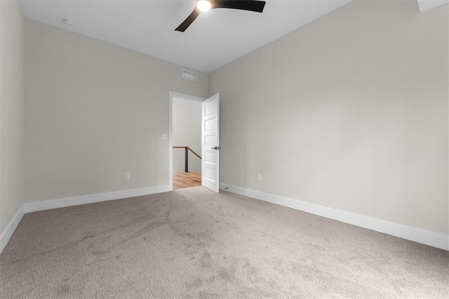 carpeted empty room featuring ceiling fan