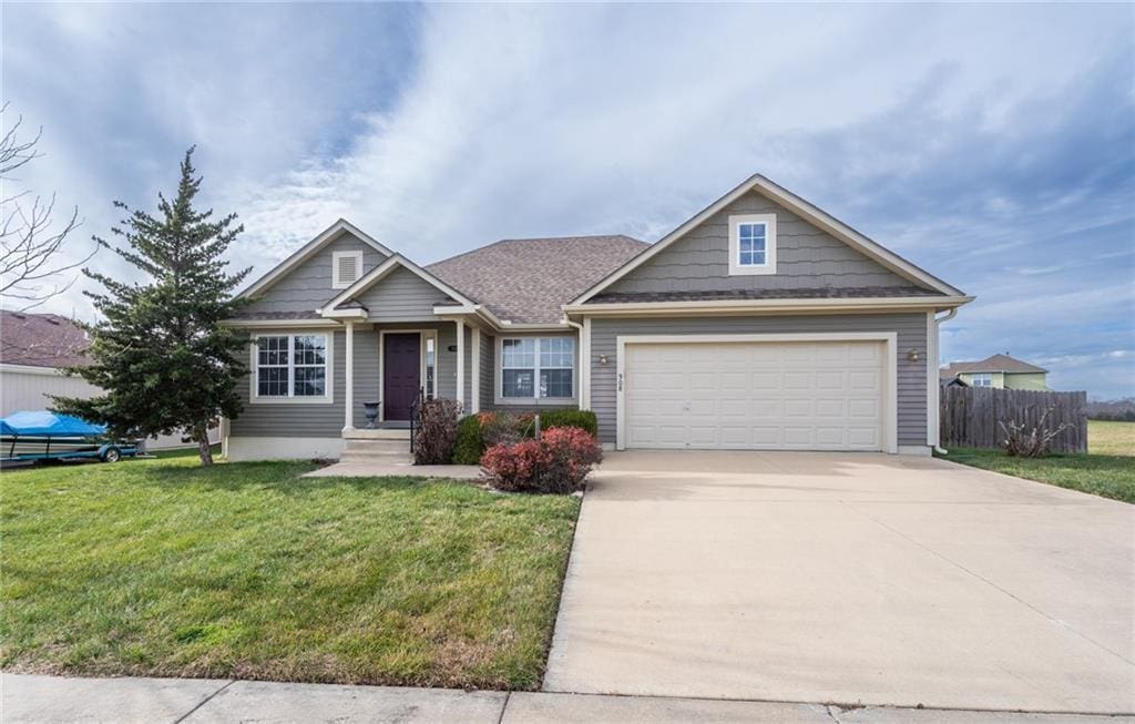 view of front facade with a garage and a front lawn