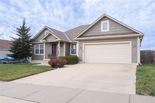 view of front of home featuring a garage and a front lawn