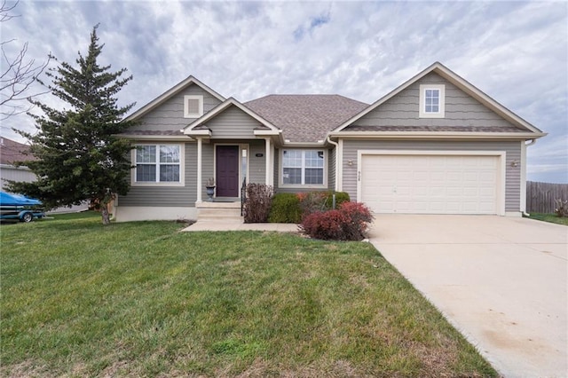 view of front of home featuring a front lawn and a garage