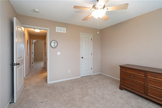 unfurnished bedroom featuring light colored carpet and ceiling fan