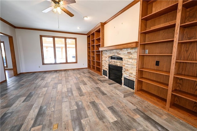 unfurnished living room with dark hardwood / wood-style flooring, ceiling fan, a stone fireplace, and ornamental molding