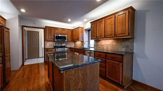 22812 E Bradford Ln, Blue Springs, MO 64015 - kitchen with stainless steel appliances, dark wood-style flooring, decorative backsplash, a kitchen island, and recessed lighting
