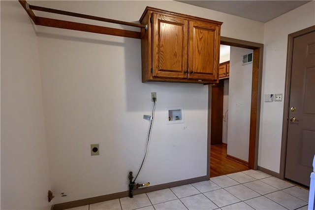 laundry area featuring cabinets, washer hookup, hookup for an electric dryer, gas dryer hookup, and light tile patterned flooring