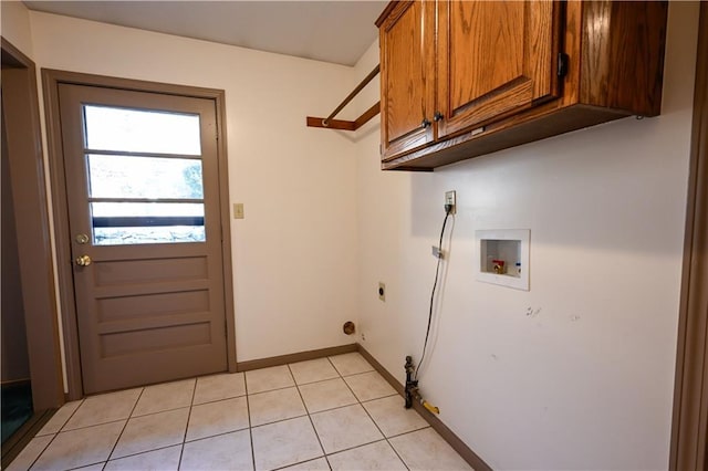 clothes washing area featuring cabinets, washer hookup, hookup for an electric dryer, and light tile patterned flooring