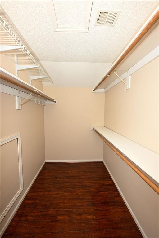 walk in closet featuring dark hardwood / wood-style flooring