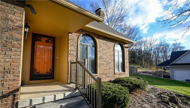 22812 E Bradford Ln, Blue Springs, MO 64015 - view of exterior entry with brick siding and a chimney