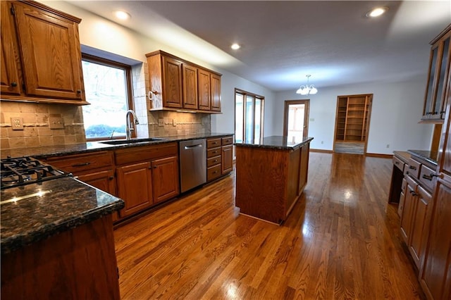 22812 E Bradford Ln, Blue Springs, MO 64015 - kitchen featuring dishwasher, dark wood-type flooring, tasteful backsplash, a center island, and brown cabinets
