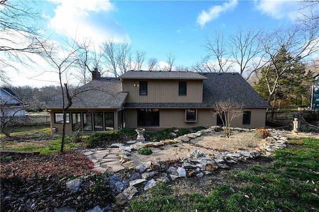 22812 E Bradford Ln, Blue Springs, MO 64015 - back of property featuring a chimney and a sunroom