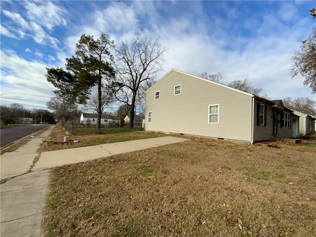 view of property exterior featuring a lawn