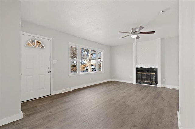 unfurnished living room with a fireplace, hardwood / wood-style floors, and ceiling fan