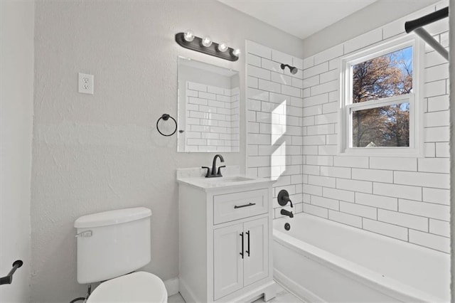 full bathroom featuring vanity, tiled shower / bath combo, and toilet