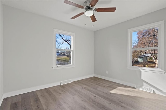 empty room with ceiling fan and light wood-type flooring