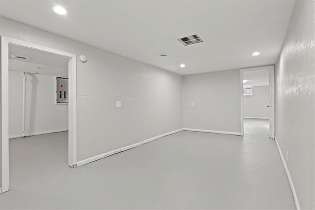 unfurnished room featuring concrete flooring and electric panel