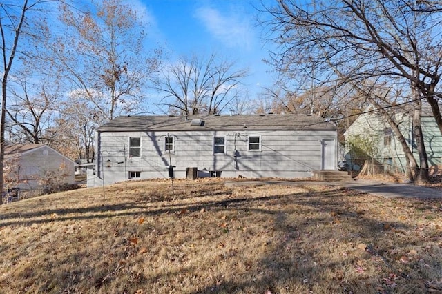 back of property featuring a lawn